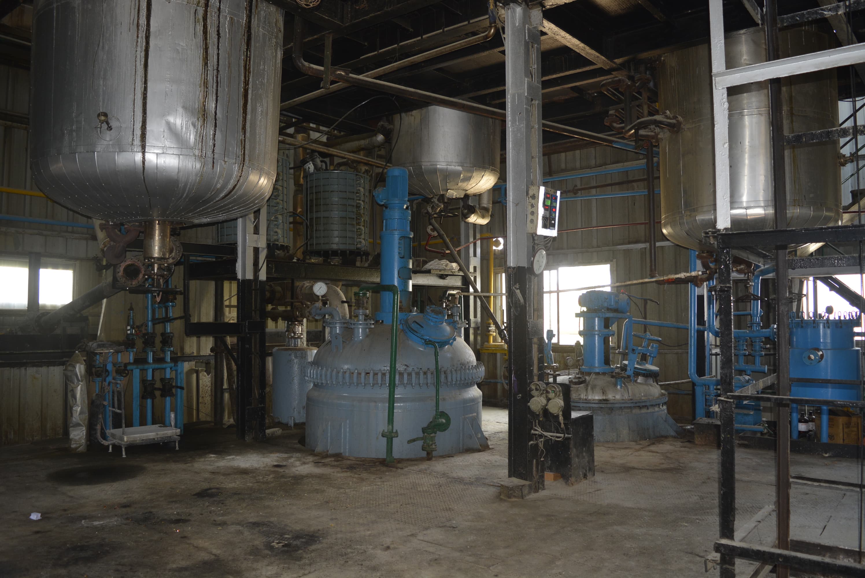 The lower level of the oil processing area, showing reactor bases and transfer lines