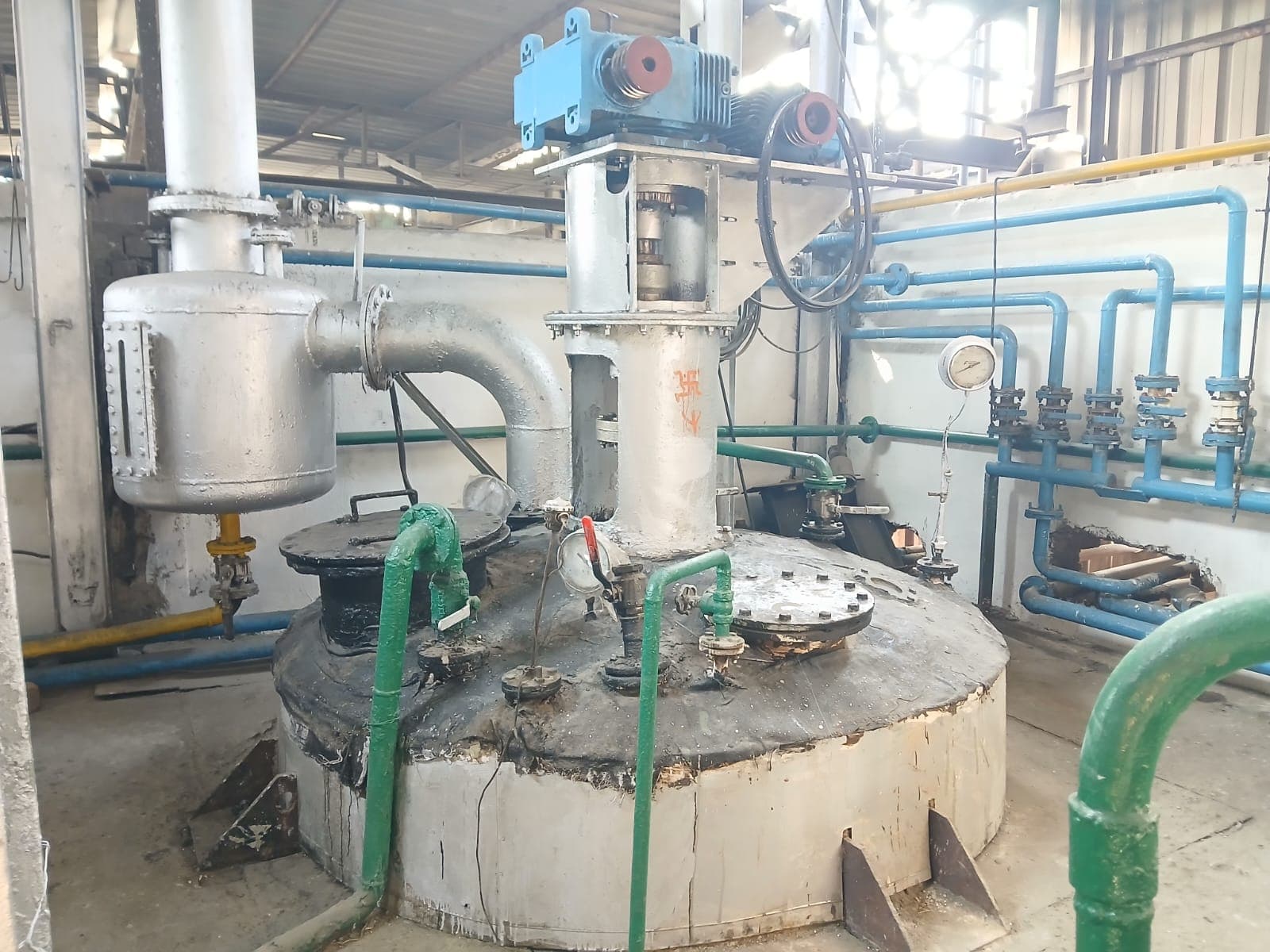 Close view of an oil reactor vessel and its discharge pipework